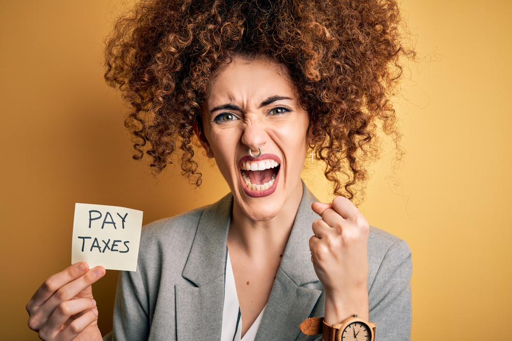 Angry woman paying taxes.