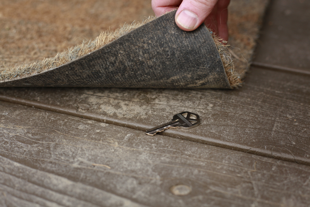 Spare key under door mat.