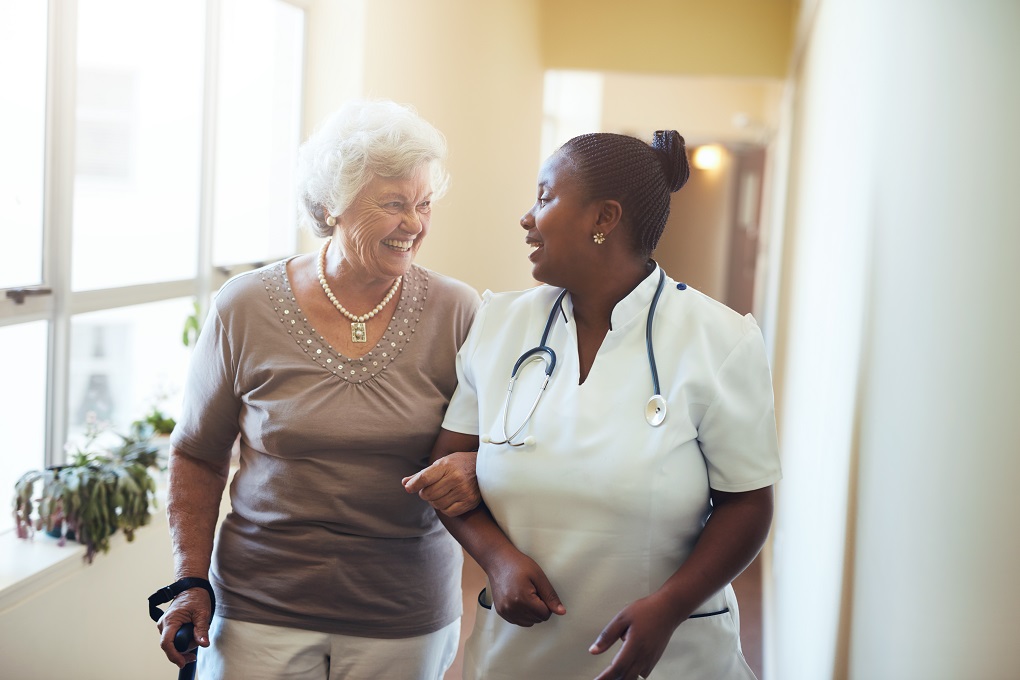 Nurse helping out elderly patient.